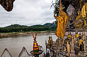 Luang Prabang, Laos - The Pak Ou Caves, the lower cave called Tham Ting. The caves, a Buddhist pilgrimage site, are a repository of old Buddha statues. 
